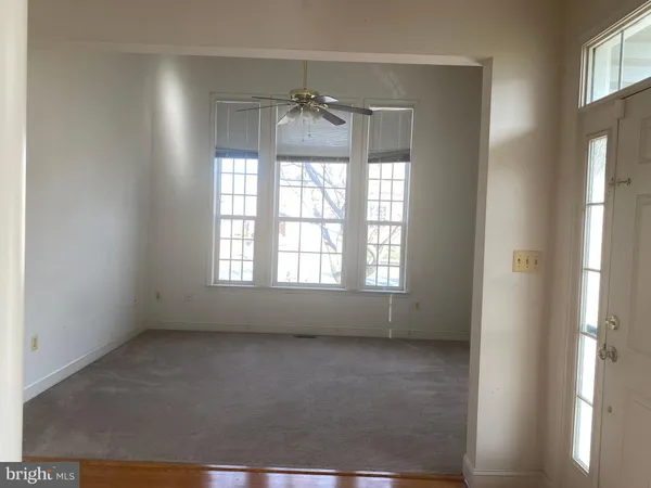 a room with window and chandelier fan