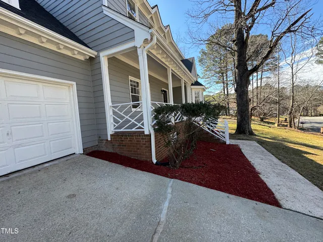 a view of a house with snow on the road