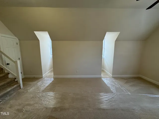 a view of a backyard with wooden fence