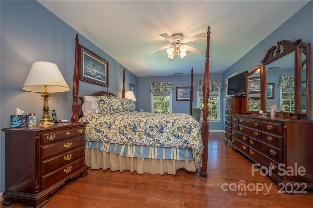 375 General Griffith Circle Rutherfordton, NC 28139 - Photo 23 of 36 a bedroom with a bed and a chandelier