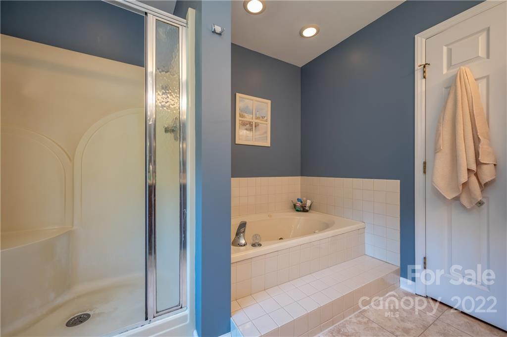 375 General Griffith Circle Rutherfordton, NC 28139 - Photo 24 of 36 a bathroom with a tub and a shower