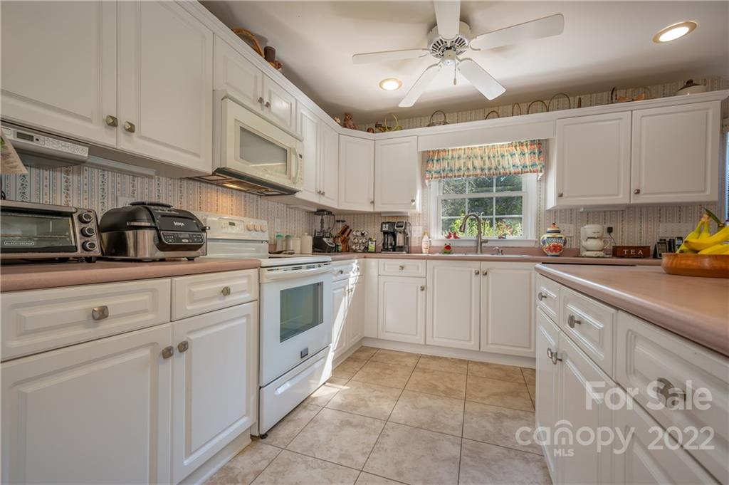 375 General Griffith Circle Rutherfordton, NC 28139 - Photo 5 of 36 a kitchen with cabinets appliances a sink and a window