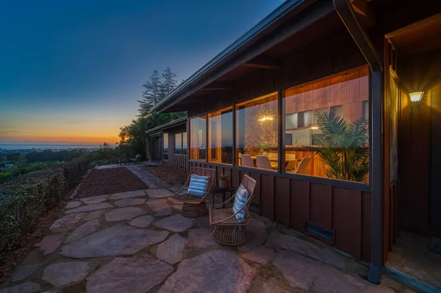 a view of a house with a yard and basketball court