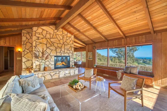 a living room filled with furniture and a floor to ceiling window