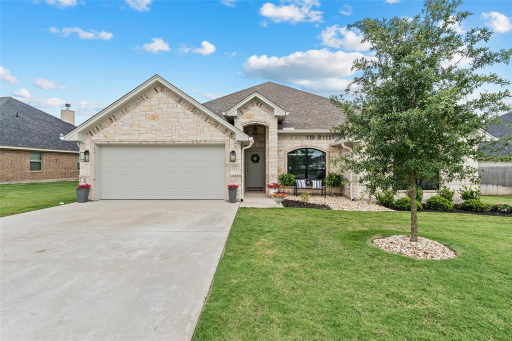 828 Agile Street Hewitt, TX 76643 - Photo 3 of 30 a front view of a house with a garden and plants
