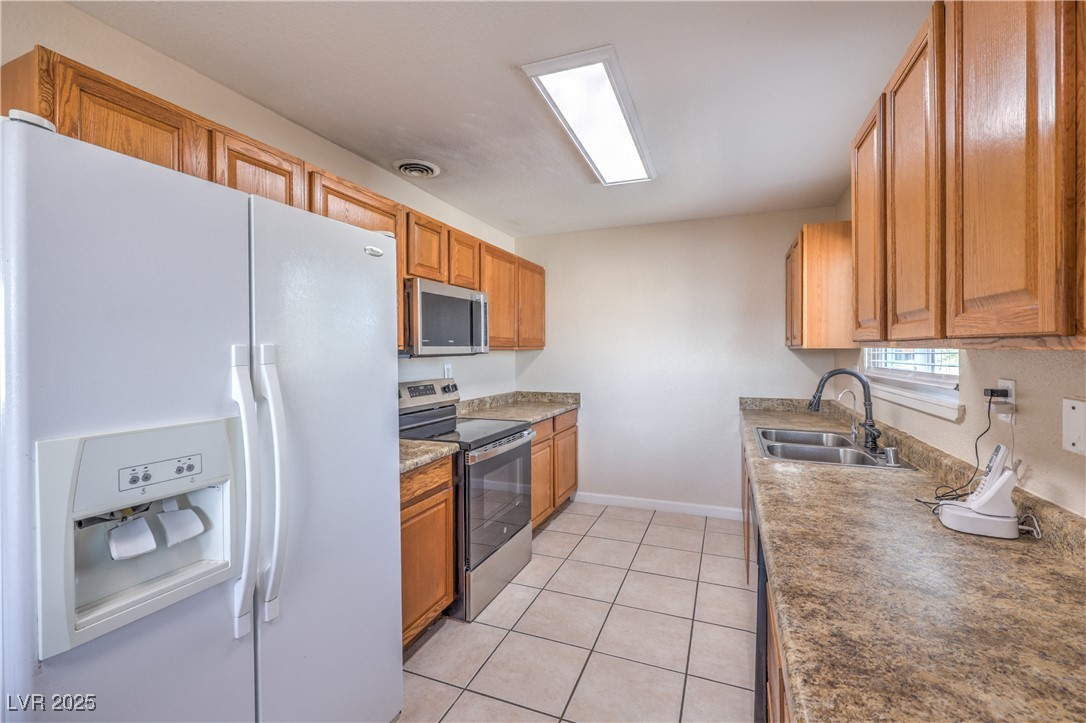 100 Maple Street Henderson, NV 89015 - Photo 8 of 29 Kitchen with appliances and tile flooring