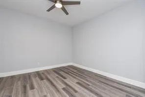 a view of a room with wooden floor