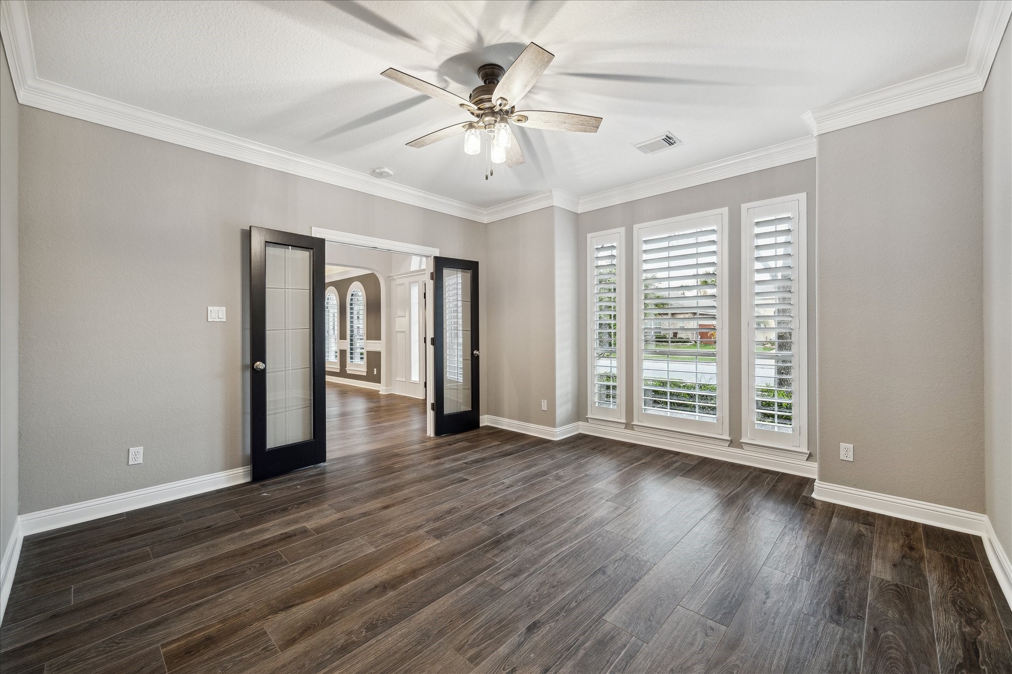 6211 Alameda Point Lane Houston, TX 77041 - Photo 9 of 50 Spacious private study showcasing generous square footage, classic plantation shutters, and elegant French doors.