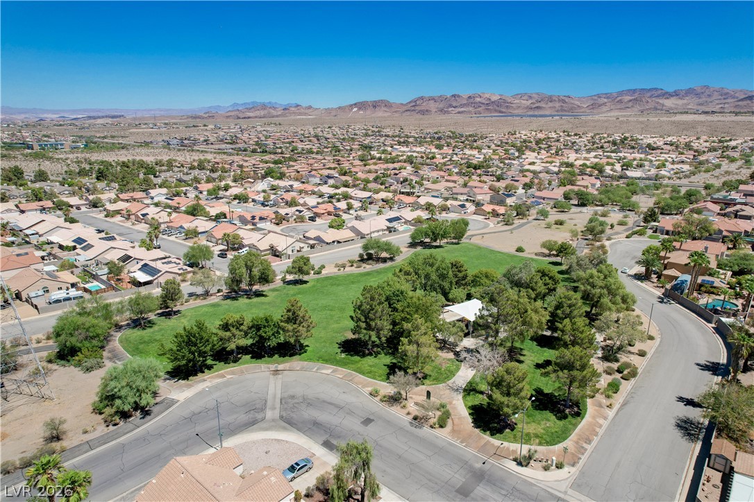 811 Rio Poco Court Henderson, NV 89015 - Photo 41 of 42 An aerial perspective reveals a vast community nestled against a desert mountain range.