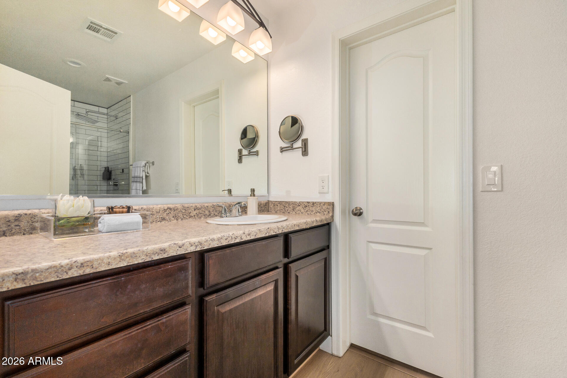 2725 East Mine Creek Road, Unit 1101 Phoenix, AZ 85024 - Photo 20 of 43 a bathroom with a granite countertop sink and a mirror