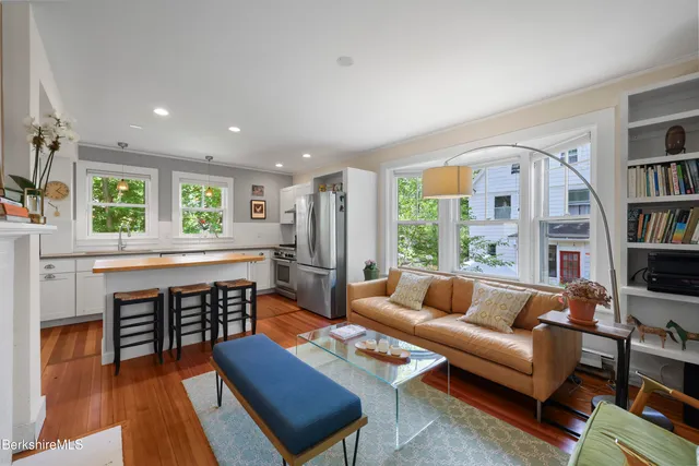 a living room with furniture and a book shelf