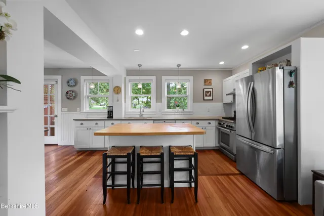 a large kitchen with a table and chairs in it