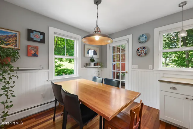 a dining room with furniture a window and a chandelier