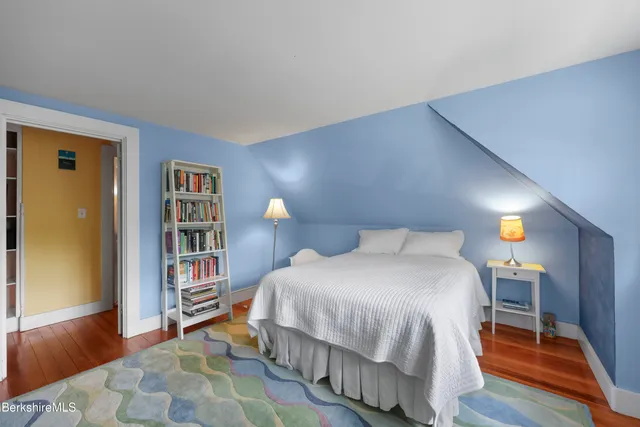 a bedroom with a bed and a book shelf