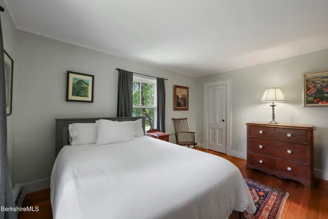 a bedroom with a bed and a night stand