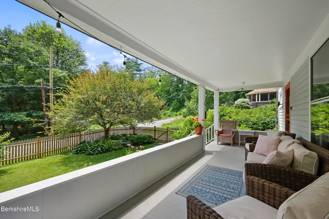 a balcony with furniture and garden view