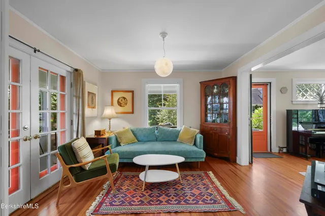 a living room with furniture a rug and a window