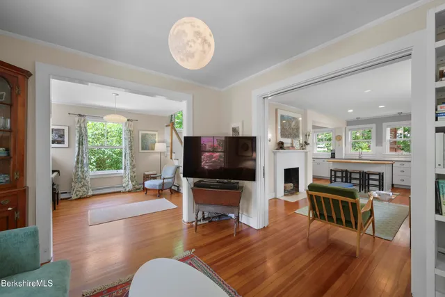 a living room with furniture flat screen tv and wooden floor