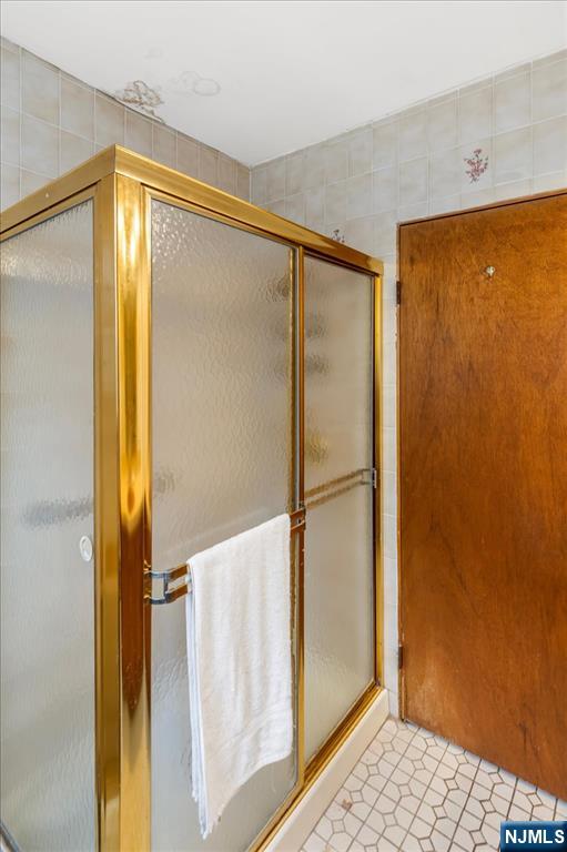 7 Delafield Avenue Rutherford, NJ 07070 - Photo 12 of 30 a bathroom with a glass shower door
