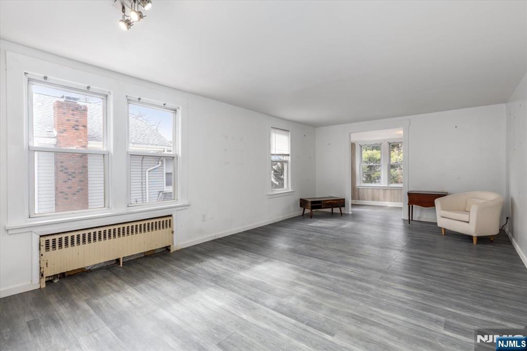 7 Delafield Avenue Rutherford, NJ 07070 - Photo 19 of 30 a view of an empty room with a window and wooden floor