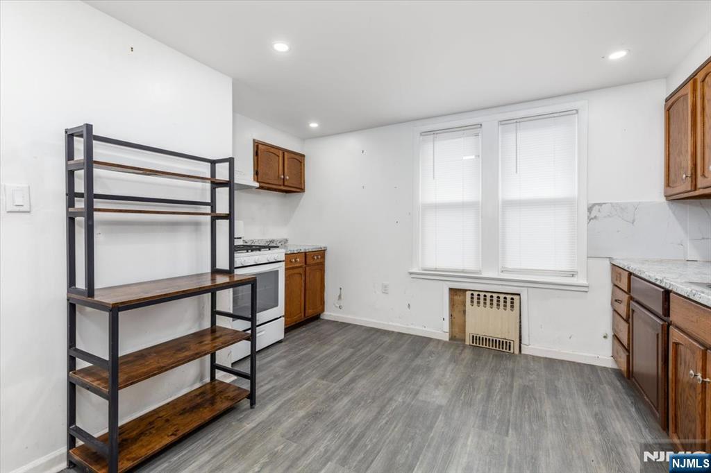 7 Delafield Avenue Rutherford, NJ 07070 - Photo 20 of 30 a kitchen with white cabinets and wooden floor
