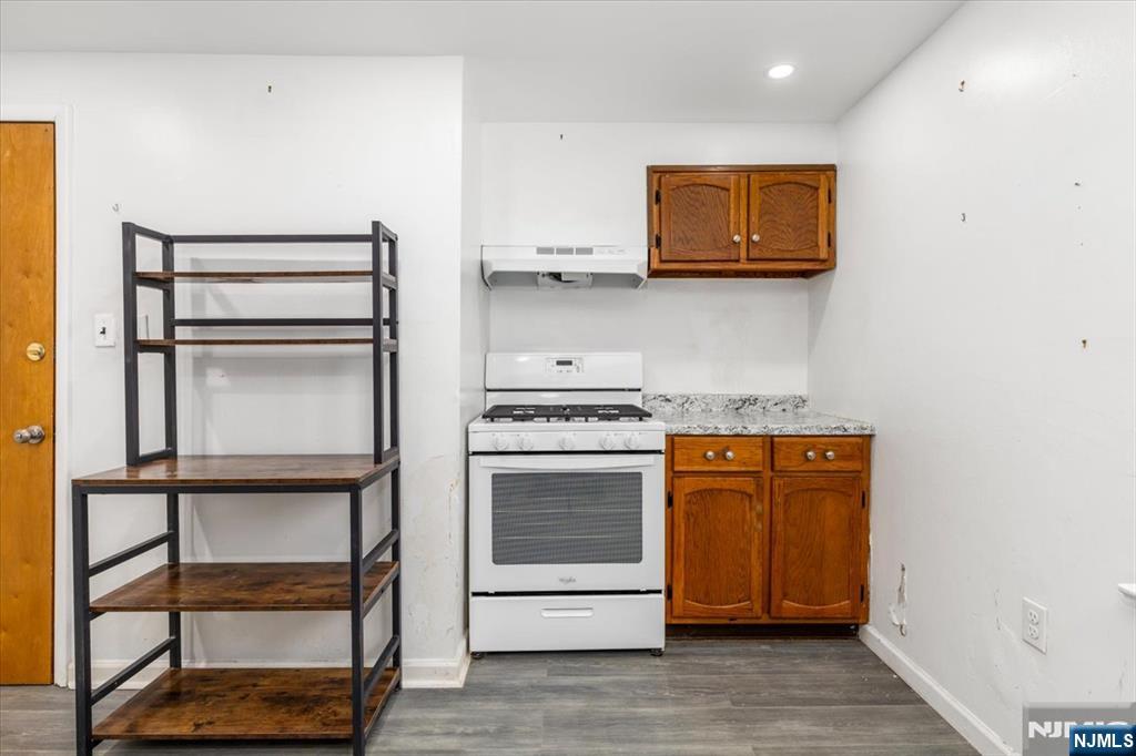 7 Delafield Avenue Rutherford, NJ 07070 - Photo 21 of 30 a kitchen with stainless steel appliances granite countertop a stove and a microwave