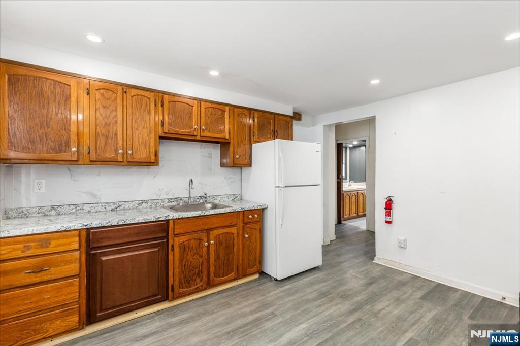 7 Delafield Avenue Rutherford, NJ 07070 - Photo 22 of 30 a kitchen with refrigerator and cabinets