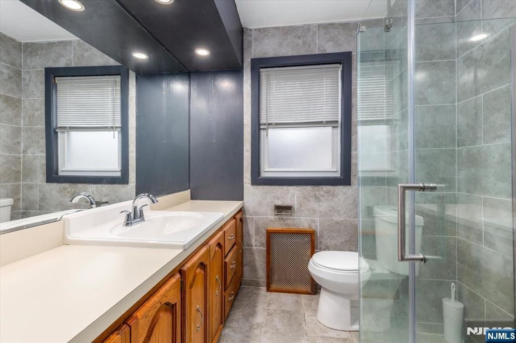 7 Delafield Avenue Rutherford, NJ 07070 - Photo 24 of 30 a bathroom with a toilet sink and mirror