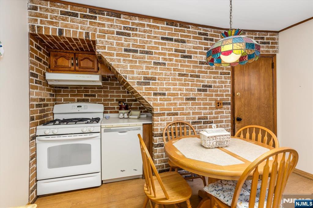 7 Delafield Avenue Rutherford, NJ 07070 - Photo 7 of 30 a kitchen with a stove and a wooden floor