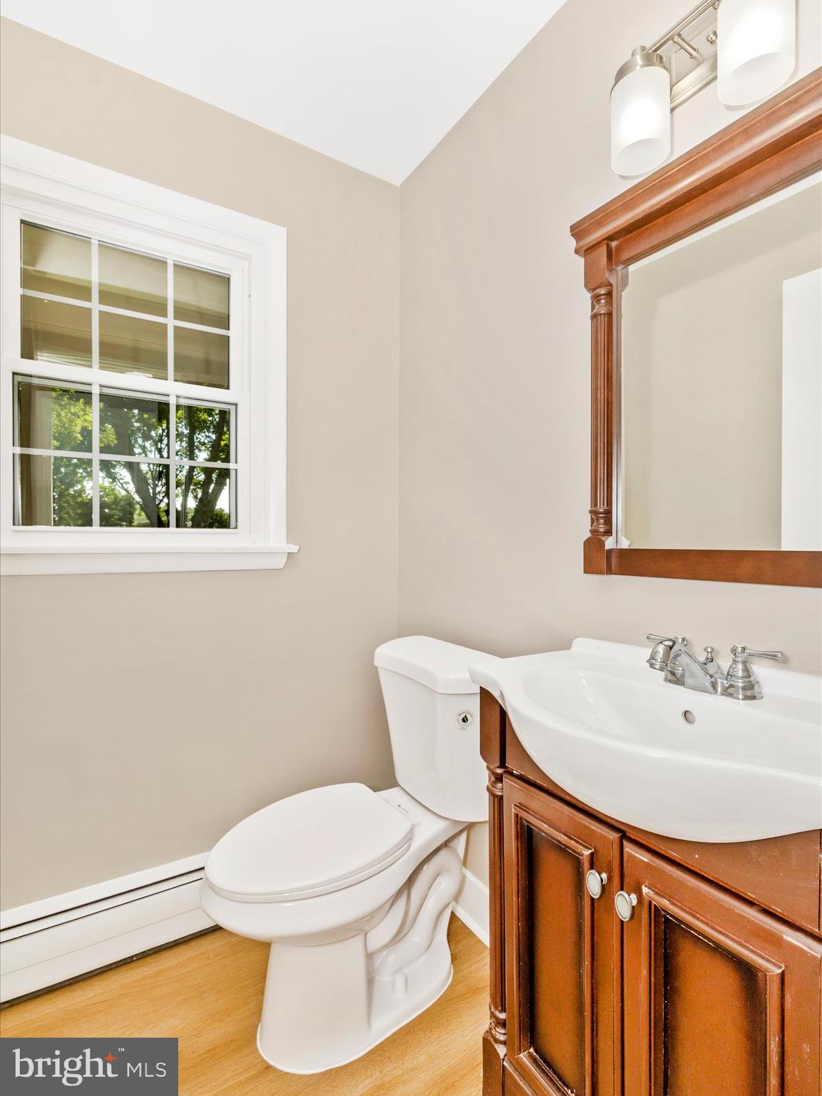 3930 Chatham Road Ellicott City, MD 21042 - Photo 11 of 51 a bathroom with a sink a toilet and mirror