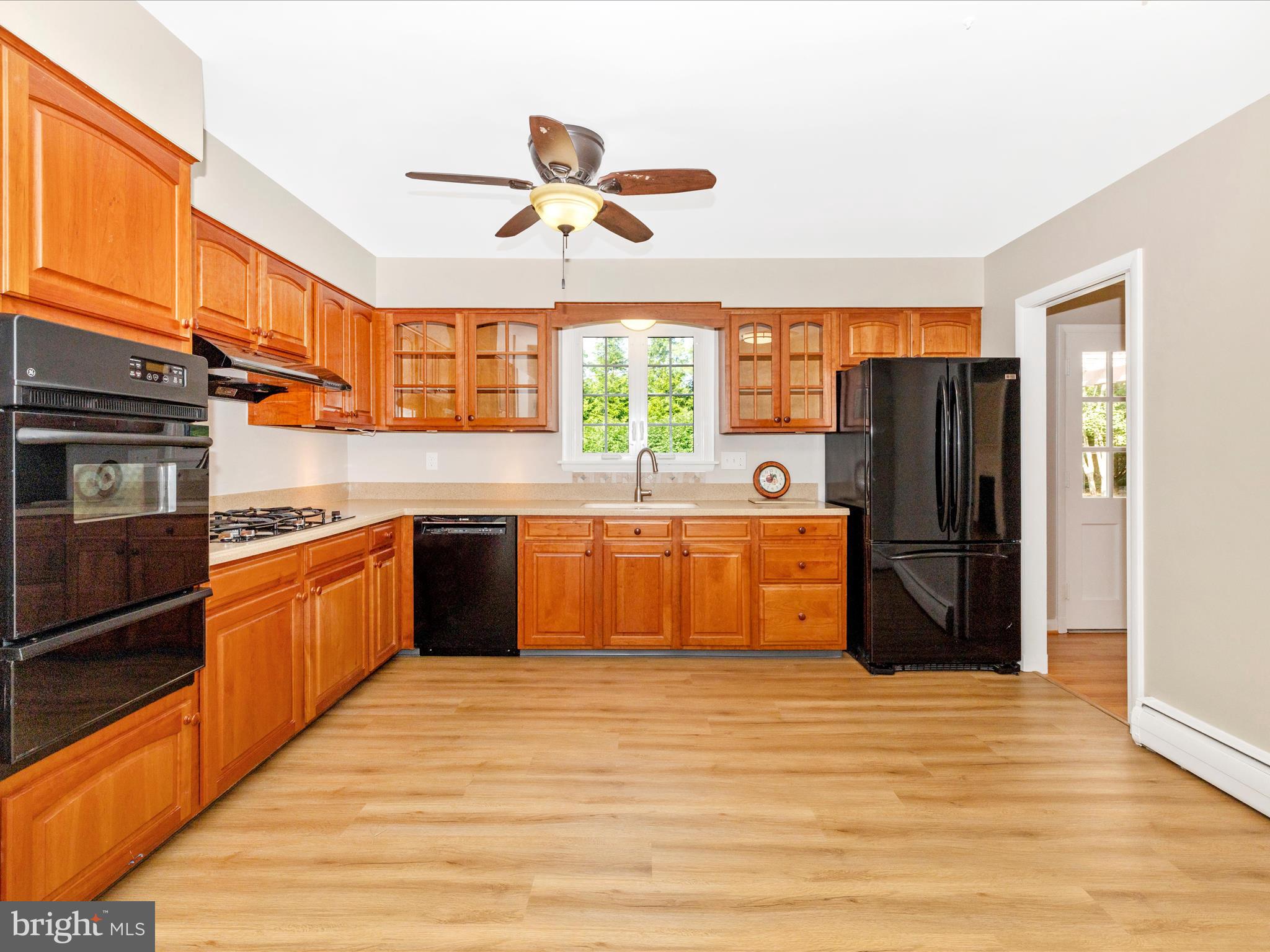 3930 Chatham Road Ellicott City, MD 21042 - Photo 18 of 51 a large kitchen with stainless steel appliances granite countertop a refrigerator a sink dishwasher a stove and a refrigerator