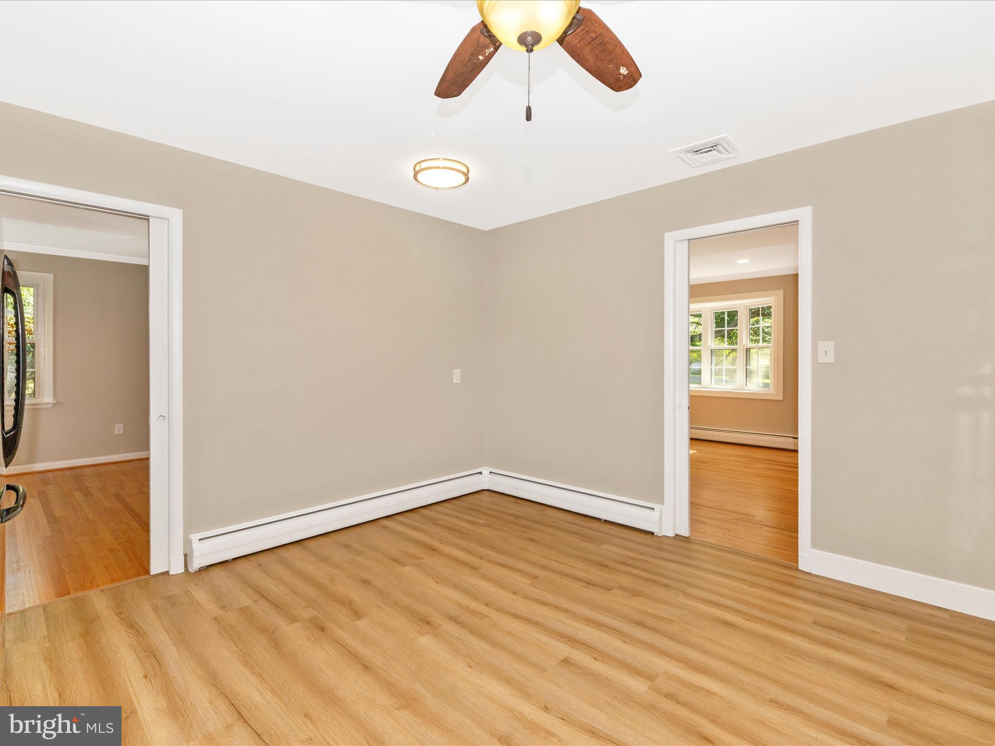 3930 Chatham Road Ellicott City, MD 21042 - Photo 20 of 51 an empty room with wooden floor cabinet and windows