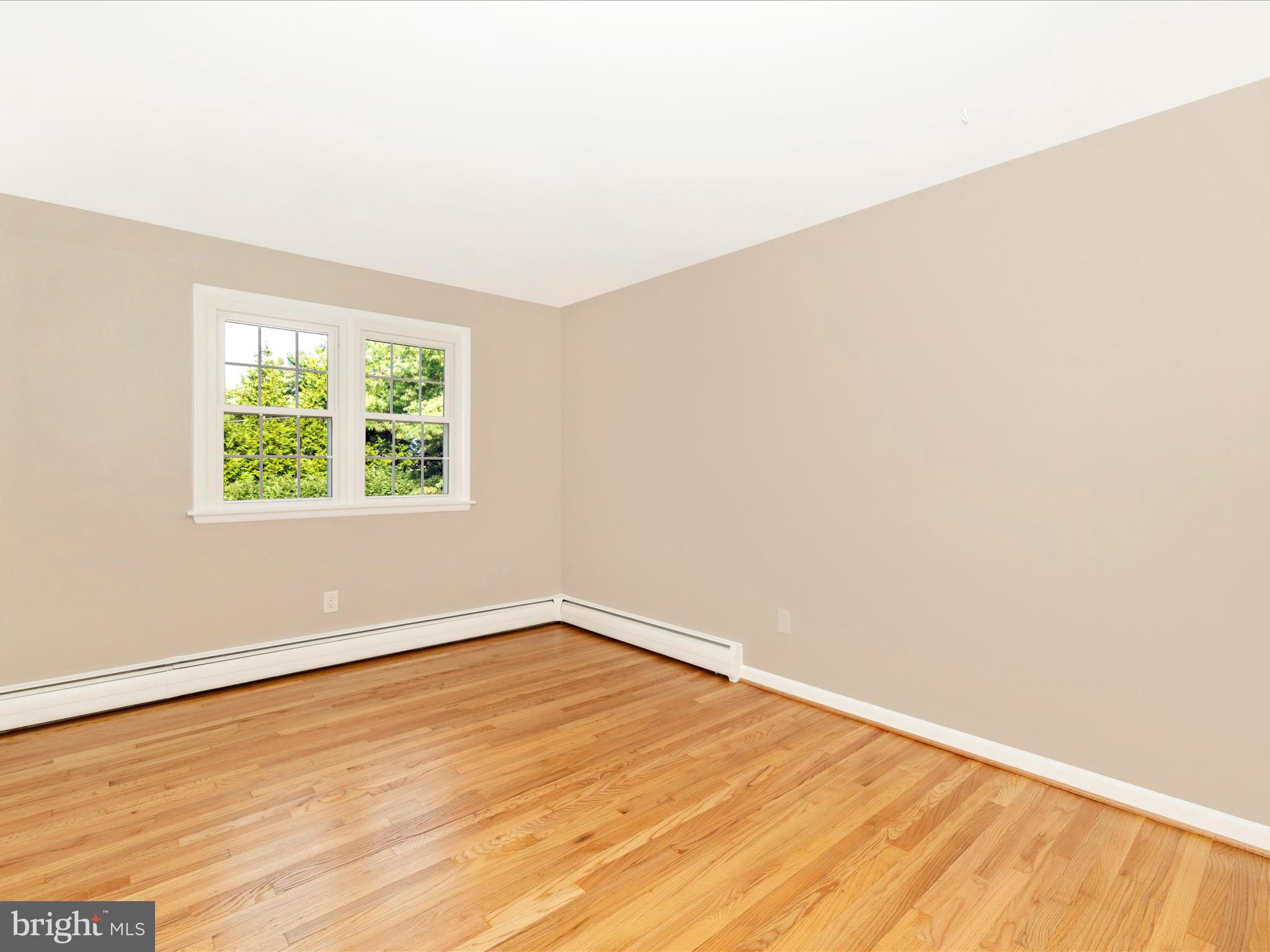 3930 Chatham Road Ellicott City, MD 21042 - Photo 28 of 51 an empty room with wooden floor and windows