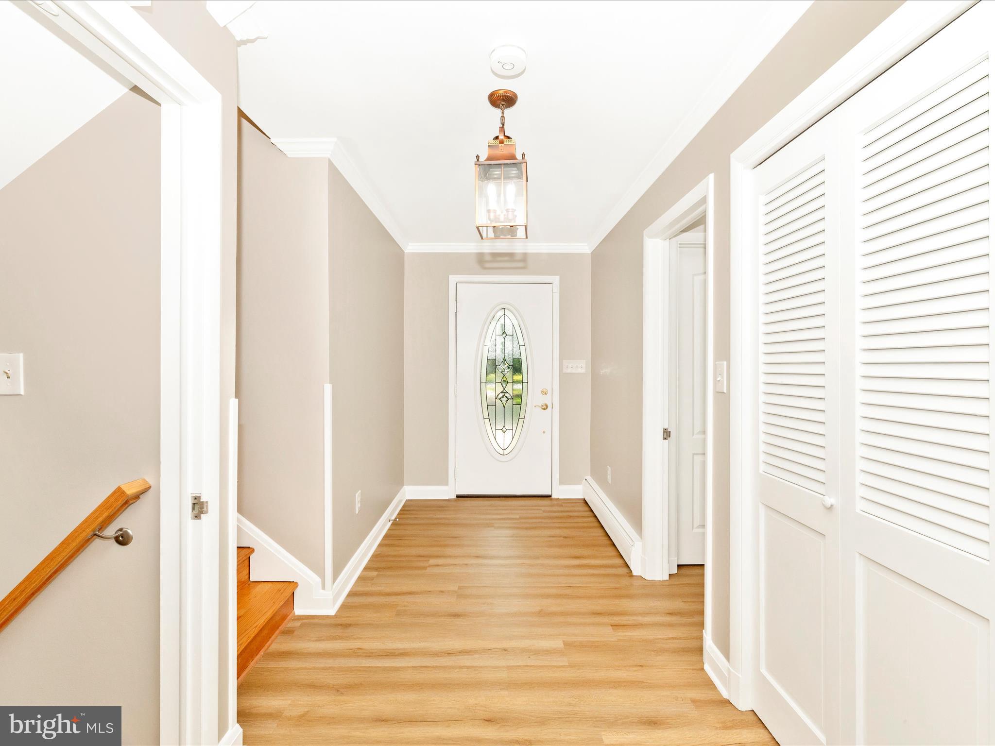3930 Chatham Road Ellicott City, MD 21042 - Photo 3 of 51 a view of a hallway with wooden floor and staircase