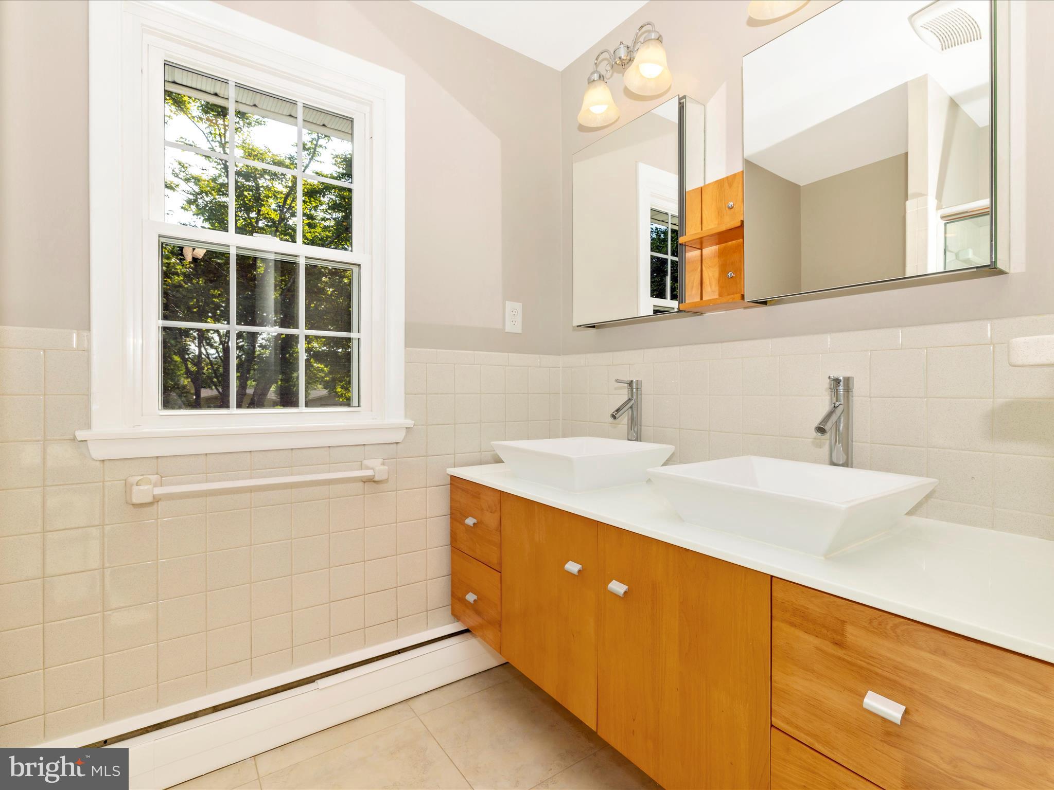 3930 Chatham Road Ellicott City, MD 21042 - Photo 32 of 51 a bathroom with a sink and a mirror