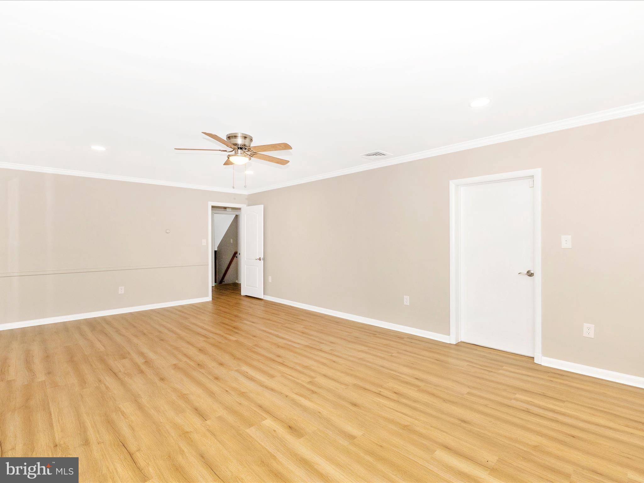 3930 Chatham Road Ellicott City, MD 21042 - Photo 6 of 51 a view of a room with wooden floor and a ceiling fan