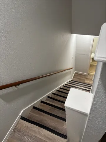 a view of staircase with wooden floor