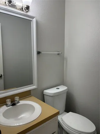 a white toilet sitting next to a bathroom sink