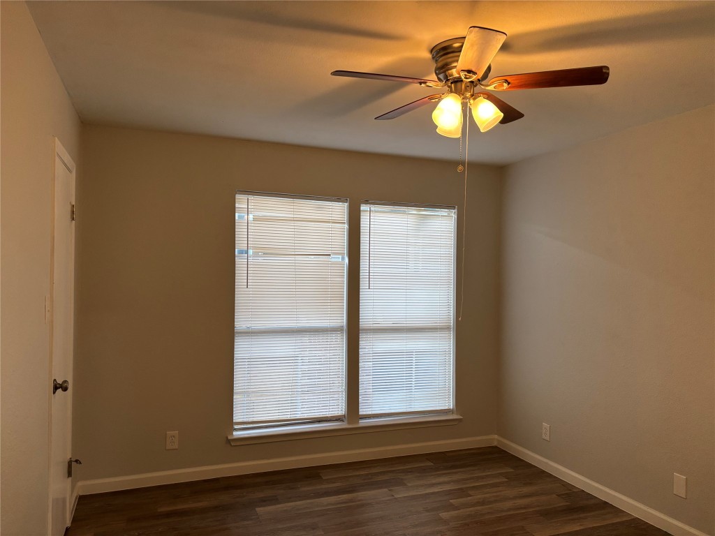 1210 Southport Drive, Unit A Austin, TX 78704 - Photo 8 of 15 a view of an empty room with wooden floor and a window