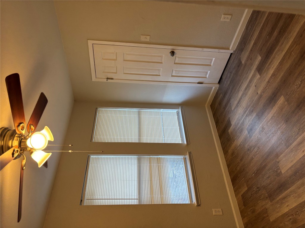 1210 Southport Drive, Unit A Austin, TX 78704 - Photo 9 of 15 a view of an empty room with wooden floor and a window