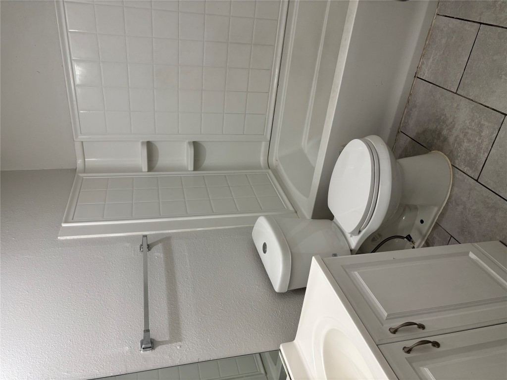 1210 Southport Drive, Unit A Austin, TX 78704 - Photo 10 of 15 a white toilet sitting next to a bath tub