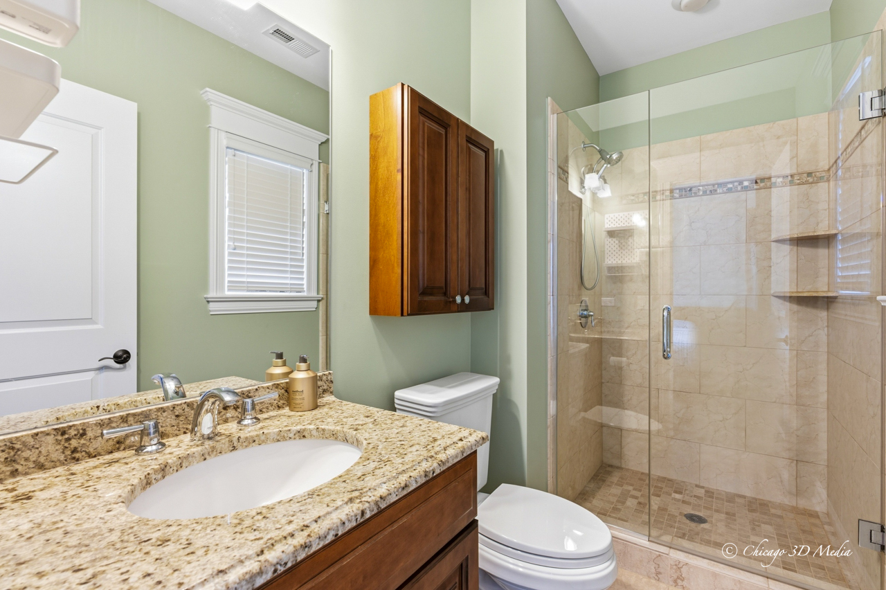 306 17th Street Wilmette, IL 60091 - Photo 30 of 48 a bathroom with a granite countertop sink toilet mirror and shower