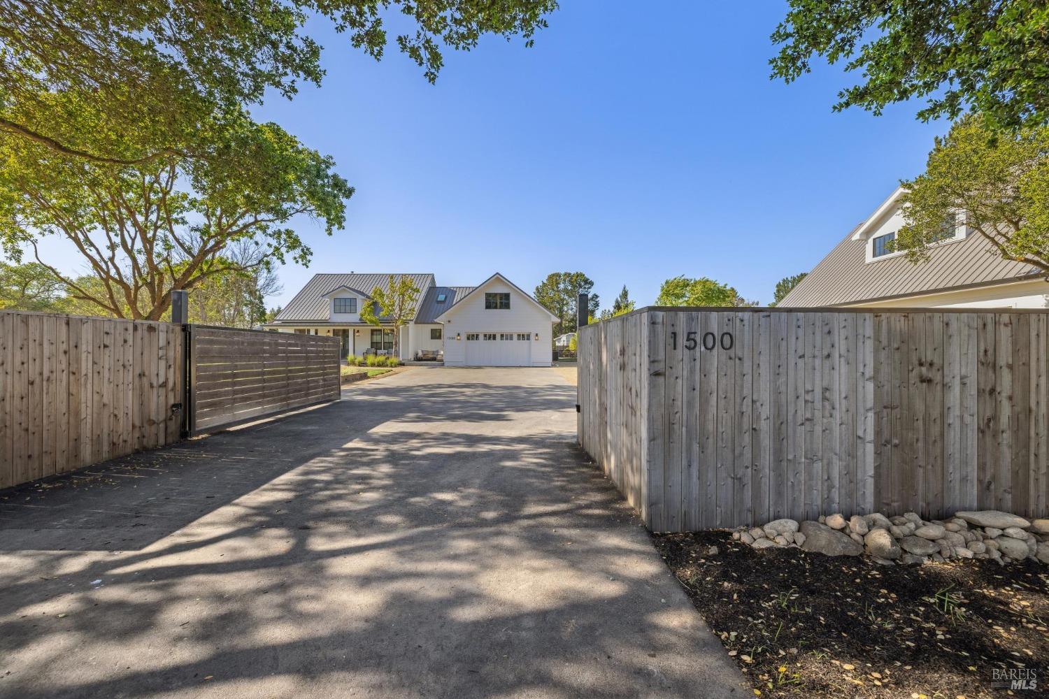 1500 Watmaugh Road Sonoma, CA 95476 - Photo 1 of 1 a view of a backyard with wooden fence and a large tree