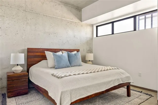 a bedroom with a bed and a night stand