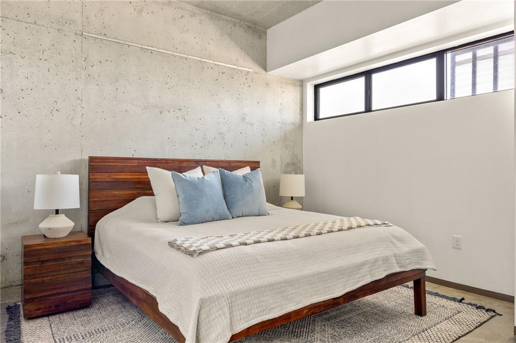 480 John Wesley Dobbs Avenue Northeast, Unit 612 Atlanta, GA 30312 - Photo 14 of 33 a bedroom with a bed and a night stand