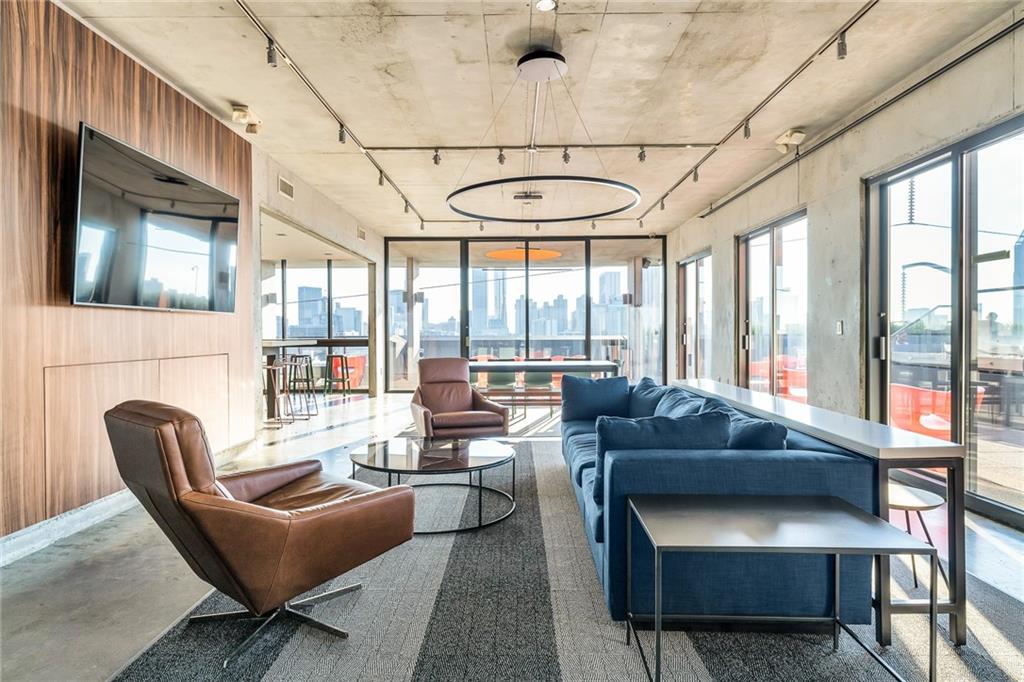 480 John Wesley Dobbs Avenue Northeast, Unit 612 Atlanta, GA 30312 - Photo 27 of 33 a living room with furniture and floor to ceiling windows