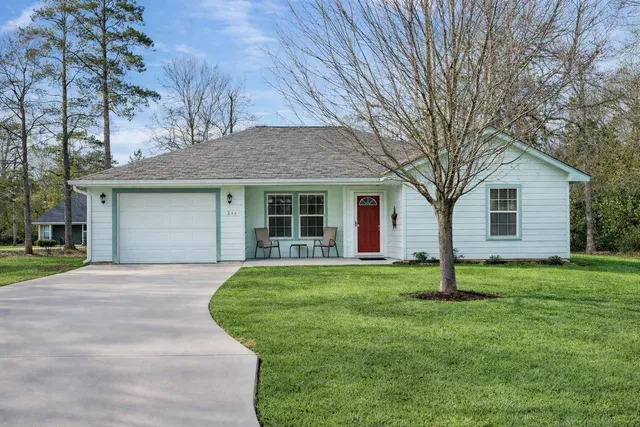 a front view of a house with a garden