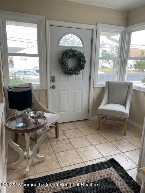 179 4th Avenue Manasquan, NJ 08736 - Photo 16 of 28 a living room with furniture and a floor to ceiling window