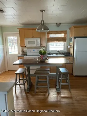 a dining room with furniture a chandelier and wooden floor