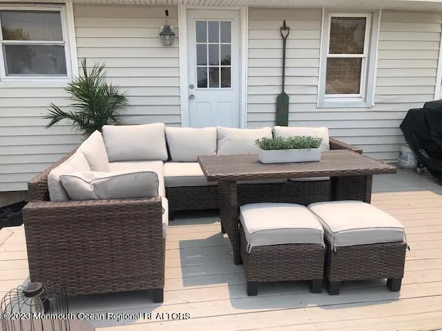 a view of a patio with couches and a potted plant on a table and chair